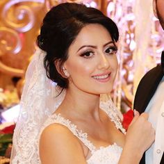 a bride and groom pose for a wedding photo