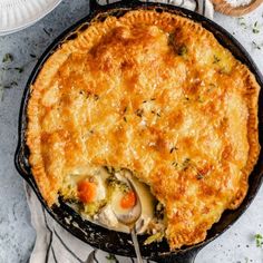 a chicken pot pie in a cast iron skillet with a serving utensil