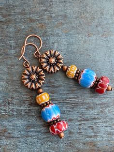 Colorful sunflower copper earrings, handmade with vintage and new chevron beads. These earrings add the perfect pop of color to your day. These will be your new favorite earrings! Product Details: *Handmade with love *Copper ear wires and sunflowers *Made with unique yellow, red, and blue chevron beads. Each bead is truly unique so you may see slight variations in color or pattern. I do my best to find complimentary pairs of beads for your earrings! * Lightweight for everyday wear To view more o Chevron Beads, Copper Earrings Handmade, Colorful Sunflower, Jewelry Rustic, Ear Ring, Sunflower Earrings, Earring Making, Earring Ideas, Blue Chevron