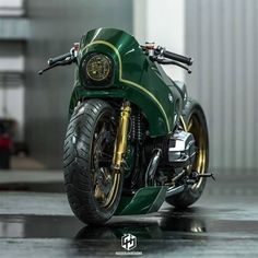 a green and gold motorcycle parked in a garage