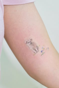 a small tattoo on the arm of a woman's left arm, with flowers all over it