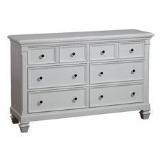 a white dresser with many drawers and knobs on the bottom drawer, in front of a white background