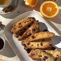 orange slices and cranberries on a white plate