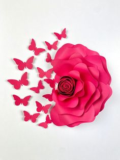 a pink rose surrounded by butterflies on a white background with the shape of a flower