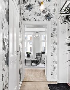 the hallway is decorated in black and white floral wallpaper