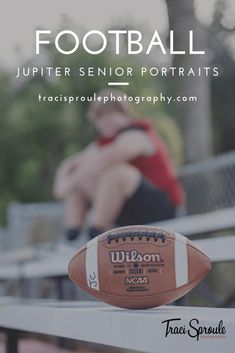 a football sitting on top of a white fence next to a man in red shirt