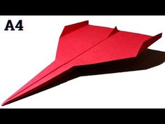 an origami paper airplane is shown in red