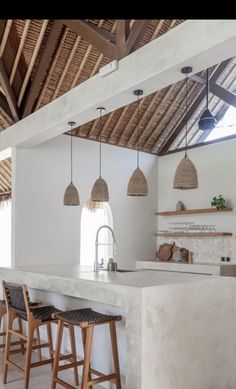 a kitchen with two bar stools next to an island