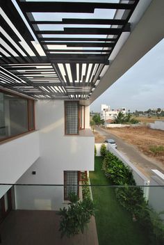 an apartment building with grass and plants on the balcony