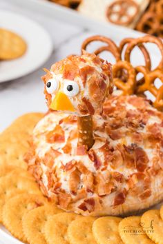 a cheese ball chicken sitting on top of crackers