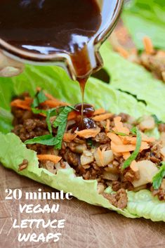 lettuce wraps filled with meat and vegetables being drizzled with sauce