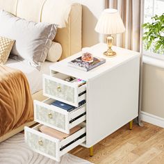 a bed room with a neatly made bed and a night stand next to a window