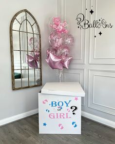 the balloon bouquet is on display in front of a mirror and box with it's name