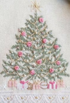 a cross stitch christmas tree with pink roses