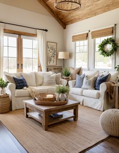 a living room filled with lots of furniture next to two windows and a rug on the floor