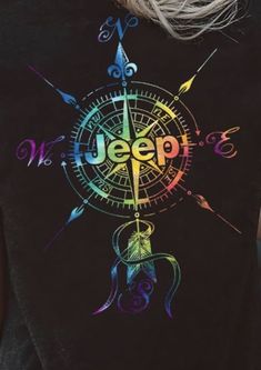 a person wearing a black shirt with an image of a compass and the words jeep on it