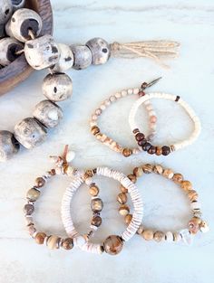 Earthy, restful, cozy, and everyday. Beautiful beige, gray, white, palest yellow, sienna, alabaster, browns, and ecru in these mixed medium stack bracelets. Several gemstone varieties in different sizes, finishes, and colors. Matte Fossilized Coral, White Turquoise, Ocean Jasper, Picture Jasper, Clear Quartz, Aventurine, Jade, Pearls, serveral varieties of Agates, many bone beads. Mix these in with earthy off-white shell, coconut disks, wood bead, natural coconut, embossed wood, African recycled Bohemian White Bracelets For Everyday, Earthy Everyday White Jewelry, White Earthy Everyday Jewelry, Casual White Hand Wrapped Beaded Bracelets, Stack Bracelets, Black Labradorite, Fossilized Coral, Handmade Lampwork Bead, Jasper Bracelet