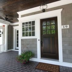 the front door of a house with two potted plants