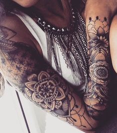 a woman with tattoos on her arm and arms