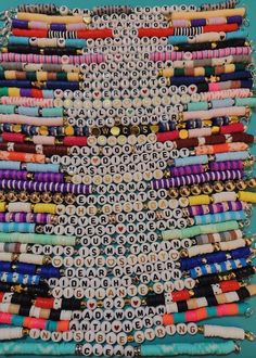 an assortment of beaded bracelets are displayed on a blue surface