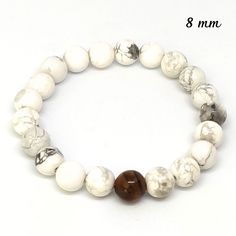 This bracelet is made with natural 8mm white howlite stones and an 8mm tiger's eye bead. Made with an elastic thread with 2 turns and knotted in 2 different places, it is secure. It fits any wrist since you select your size. With a meter or string, measure the circumference of your wrist and select the size you want. It comes in an organza bag. It is sent by letter with tracking. I make my jewelry myself and are made with care. Each stone is unique and may have slight irregularities and color va Howlite Stone, Elastic Thread, Tiger Eye Beads, White Howlite, Quartz Cluster, Tiger's Eye, Nature Bracelets, Natural Pearls, Pearl Bracelet