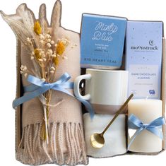 a gift box filled with coffee, candles and other items