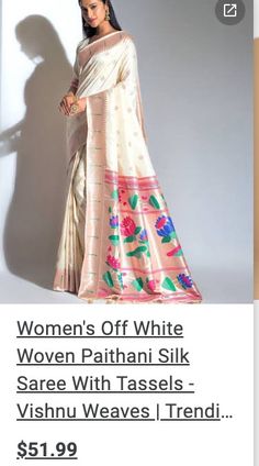 a woman's off white saree with tassels and pink flowers on it