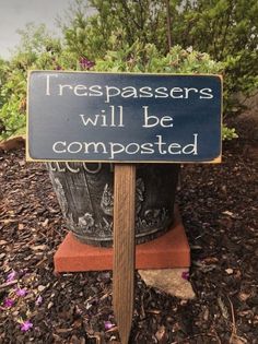 a sign that says trespassers will be composted