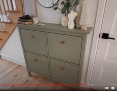 the dresser is painted gray with gold handles