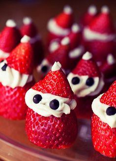 some strawberries are decorated like santa claus