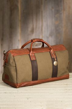 Will Barrel Canvas and Bridle Leather Duffel Bag | Overland Luxury Coated Canvas Duffle Bag For Weekend Trips, Luxury Leather-backed Duffle Bag For Weekend Trips, Luxury Men's Duffle Bag With Leather Lining, Luxury Men's Weekender Bag With Leather Handles, Luxury Men's Duffle Bag With Multiple Compartments, Luxury Men's Weekender Bag With Luggage Sleeve, Luxury Men's Weekender Bag For Travel, Luxury Men's Satchel Weekender Bag, Luxury Men's Soft Leather Weekender Bag