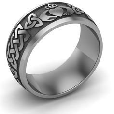 TITANIUM Claddagh Wedding Ring UCL1-TITAN10M Titanium Claddagh Wedding Ring Available in sizes from 9 through 15Available also in 10K Gold, 18K Gold, Platinum, White Gold, Yellow Gold, or Rose Gold.Our Titanium Claddagh Wedding Ring features 2 Claddagh symbols (hands, heart, and crown) on the opposite side of the ring, 4 trinity knots, and 4 Celtic knots. The length of the Celtic knot is adjusted to fit the size of the ring: smaller the size of the ring shorter the length of the Celtic knot. TIT Symbolic Hallmarked Wedding Rings, Symbolic Wedding Rings Hallmarked, Symbolic Round Band Wedding Rings, Symbolic Wedding Rings With Round Band, Symbolic Silver Couple Rings For Wedding, Claddagh Wedding Ring, Claddagh Symbol, Claddagh Ring Wedding, Titanium Wedding Rings