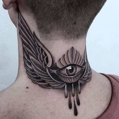 a man's neck with an all seeing eye and wings tattoo on his neck