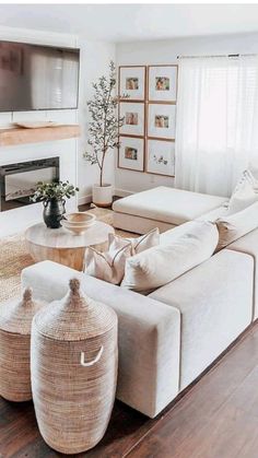 a living room filled with furniture and a flat screen tv mounted on the wall above a fire place