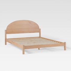 a wooden bed frame with an arched headboard