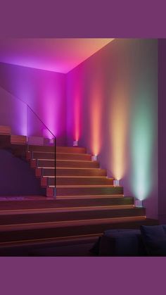 the stairs are lit up with colored lights in this room, and there is also a stair case