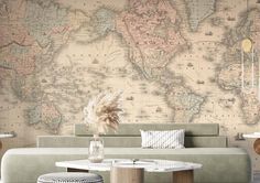 a living room with a couch, table and large map on the wall behind it