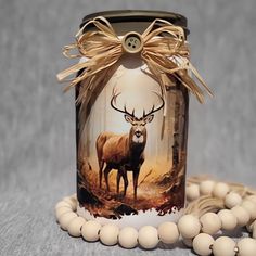 a jar that has some beads around it and a deer on the front with a bow