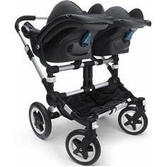 two black strollers with wheels and seats on each side, one is facing the camera