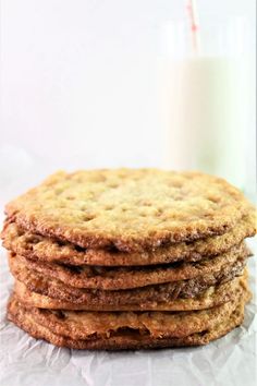 a stack of cookies sitting on top of a table next to a glass of milk