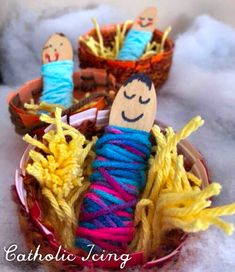 yarn wrapped doll sitting in basket with two small dolls on it's sides and text, catholic living