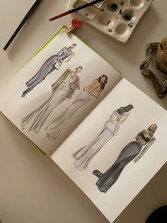 two drawings of women's clothes on paper next to paintbrushes