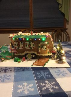 a gingerbread house is decorated with christmas lights