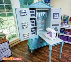 a sewing machine sitting on top of a table in front of a cabinet filled with craft supplies