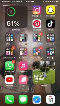 an iphone screen with many different icons on the phone and in front of it, there is