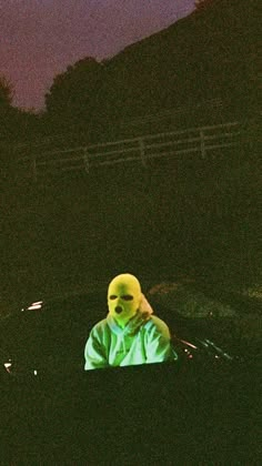 a person wearing a yellow mask in the dark