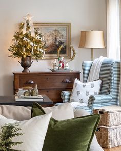 a living room filled with furniture and a christmas tree on top of a wooden table