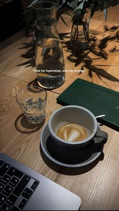 a cup of coffee sitting on top of a wooden table