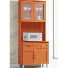 a microwave oven sitting on top of a wooden shelf next to a cabinet with glass doors