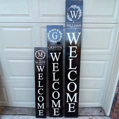 two wooden welcome signs sitting next to each other